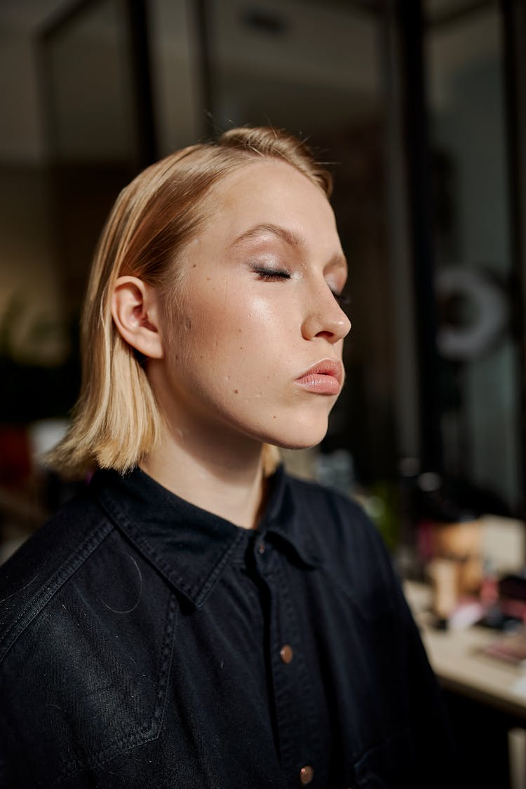 Reflective Model With Applied Makeup In Beauty Salon