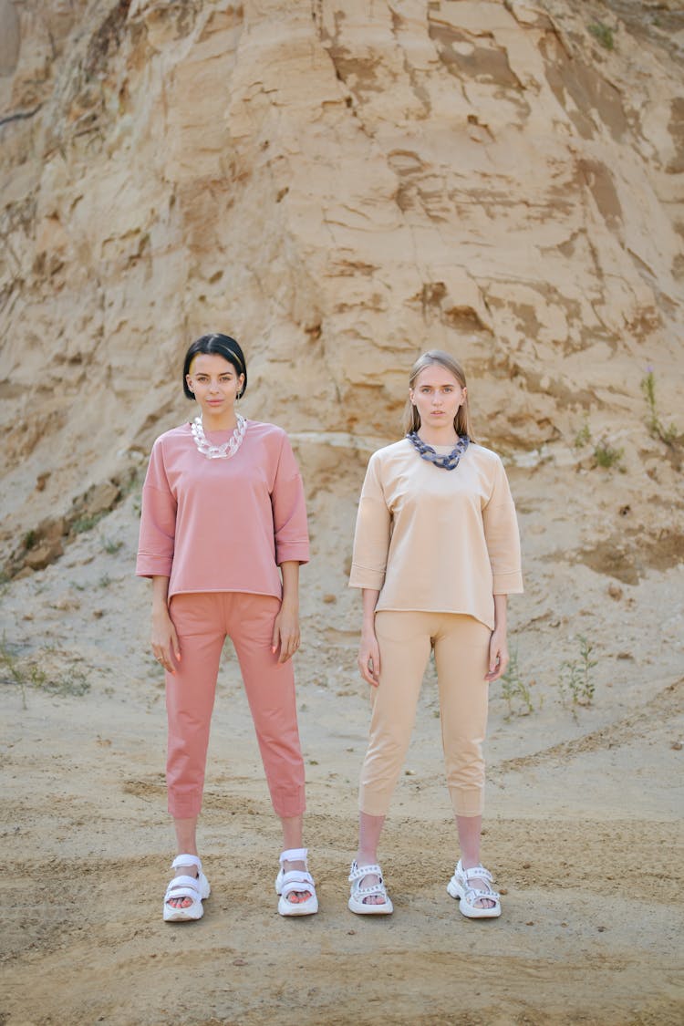 Women In Stylish Outfit Near High Mount In Desert