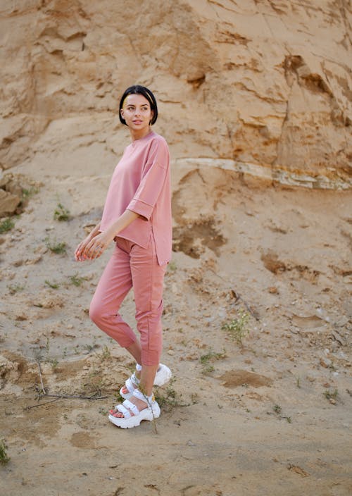 Free Trendy model in sandals near rough mountain Stock Photo