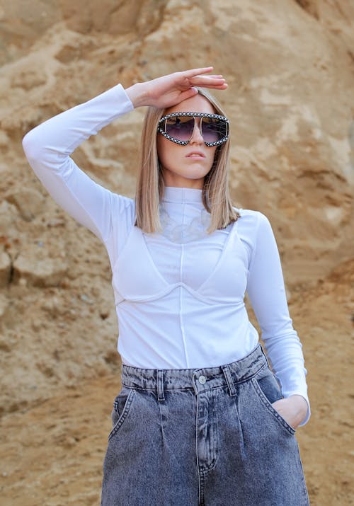Free Stylish woman in sunglasses near mount in summer Stock Photo