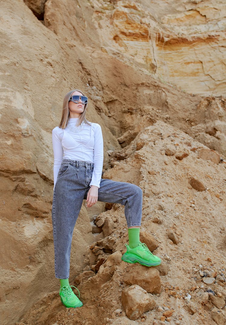 Trendy Woman In Green Sneakers On Mountain