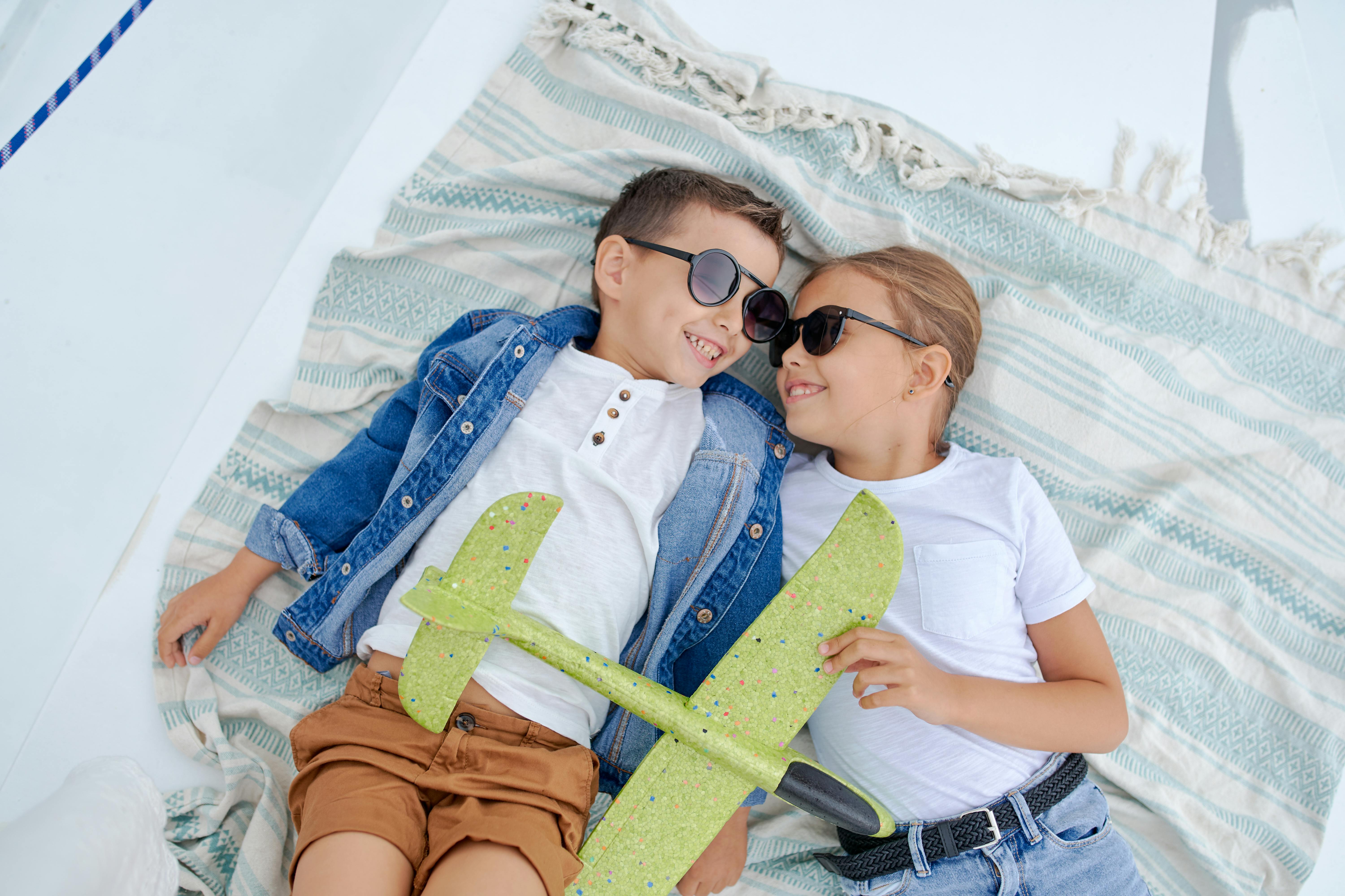 happy little boy and girl on blanket