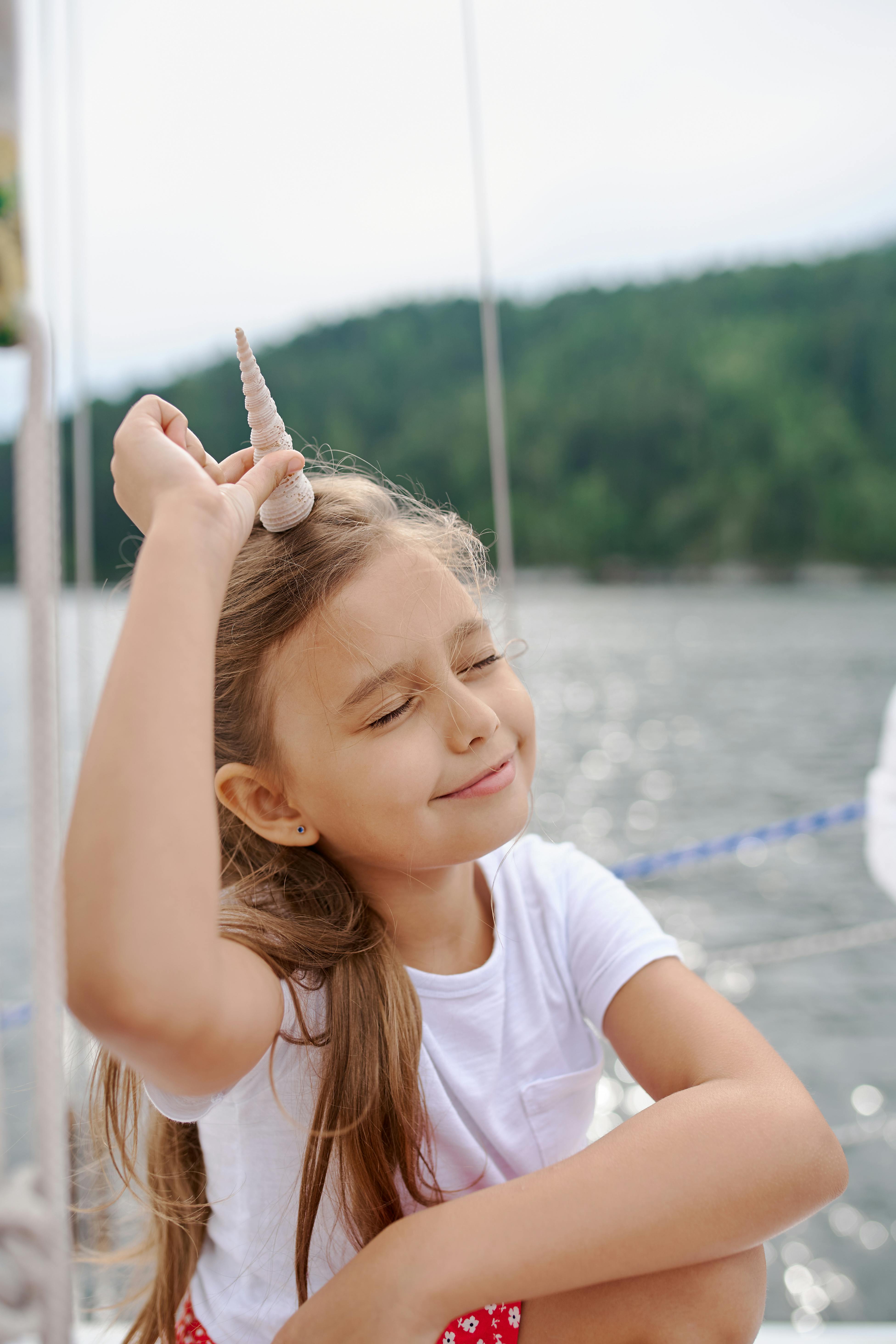 happy girl with toy resting on boat