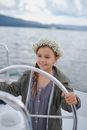 Smiling little girl sailing in sea