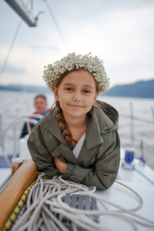 Cheerful little girl on boat in sea