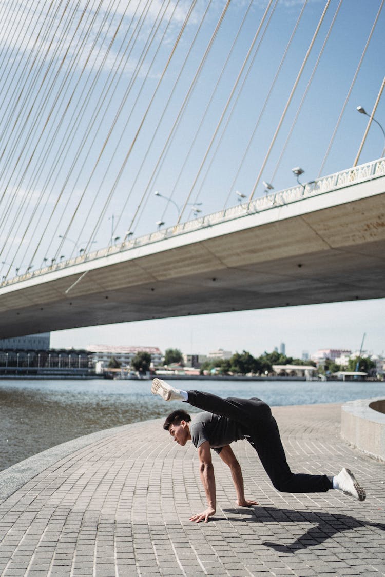 Strong Asian Man Dancing Street Dance On River Embankment