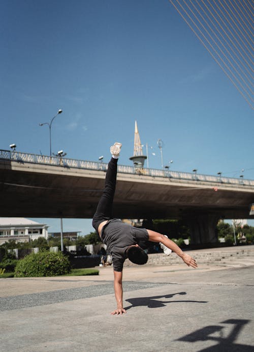 Anonymous man practicing handstand on street