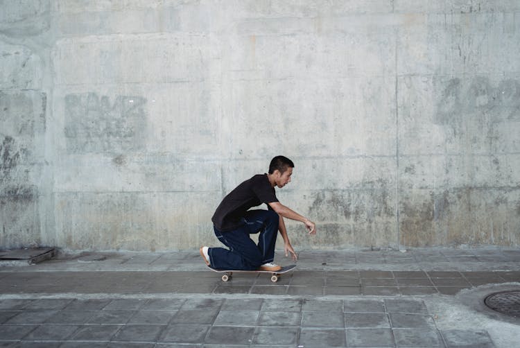 Young Asian Man Skating On Skateboard