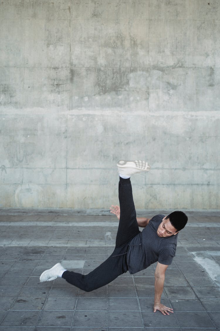 Strong Asian Man Dancing Break On Pavement