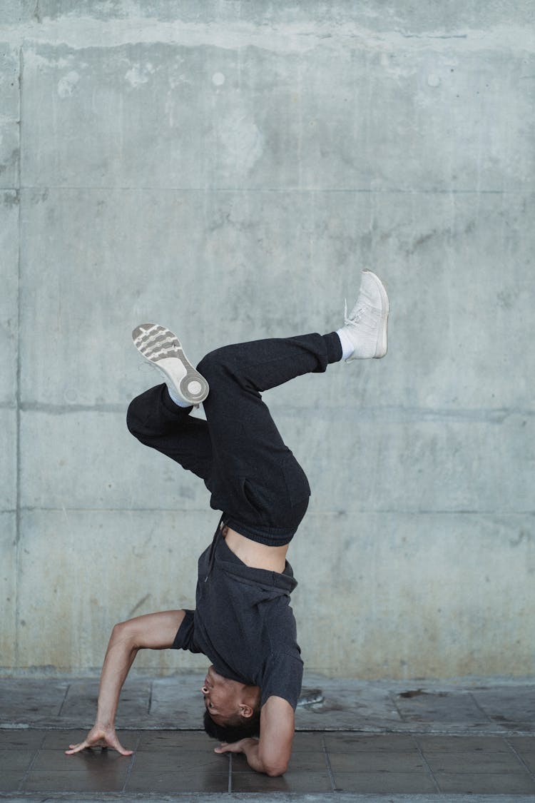 Young Guy Standing On Head During Break Dance Training