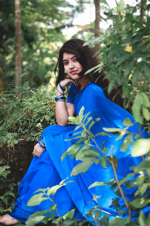 Tender ethnic woman in bright blue sari