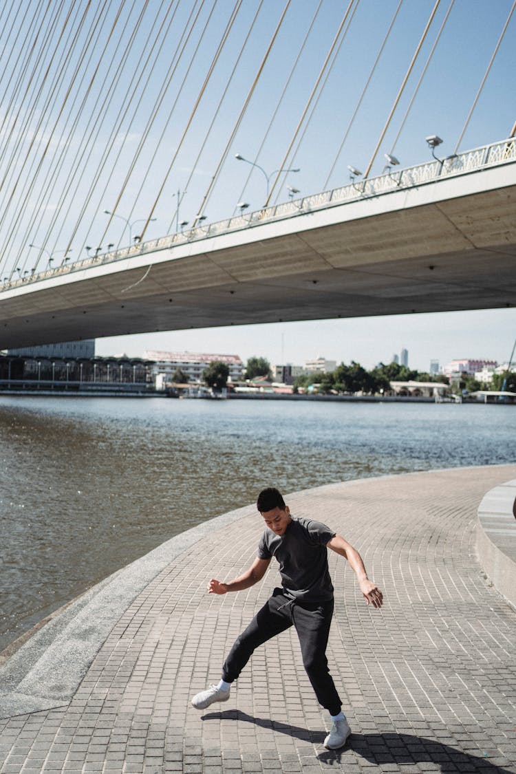 Fit Asian Break Dancer Dancing On Embankment