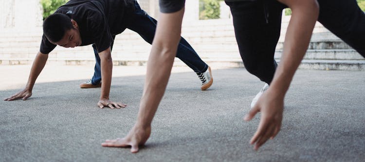 Strong Asian Men Practicing Breakdance On Street