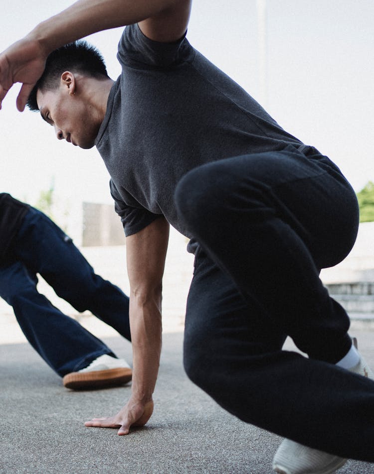 Asian Man Doing Exercises On Street