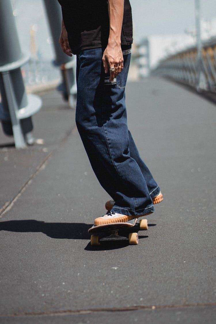 Crop Man On Skateboard In City