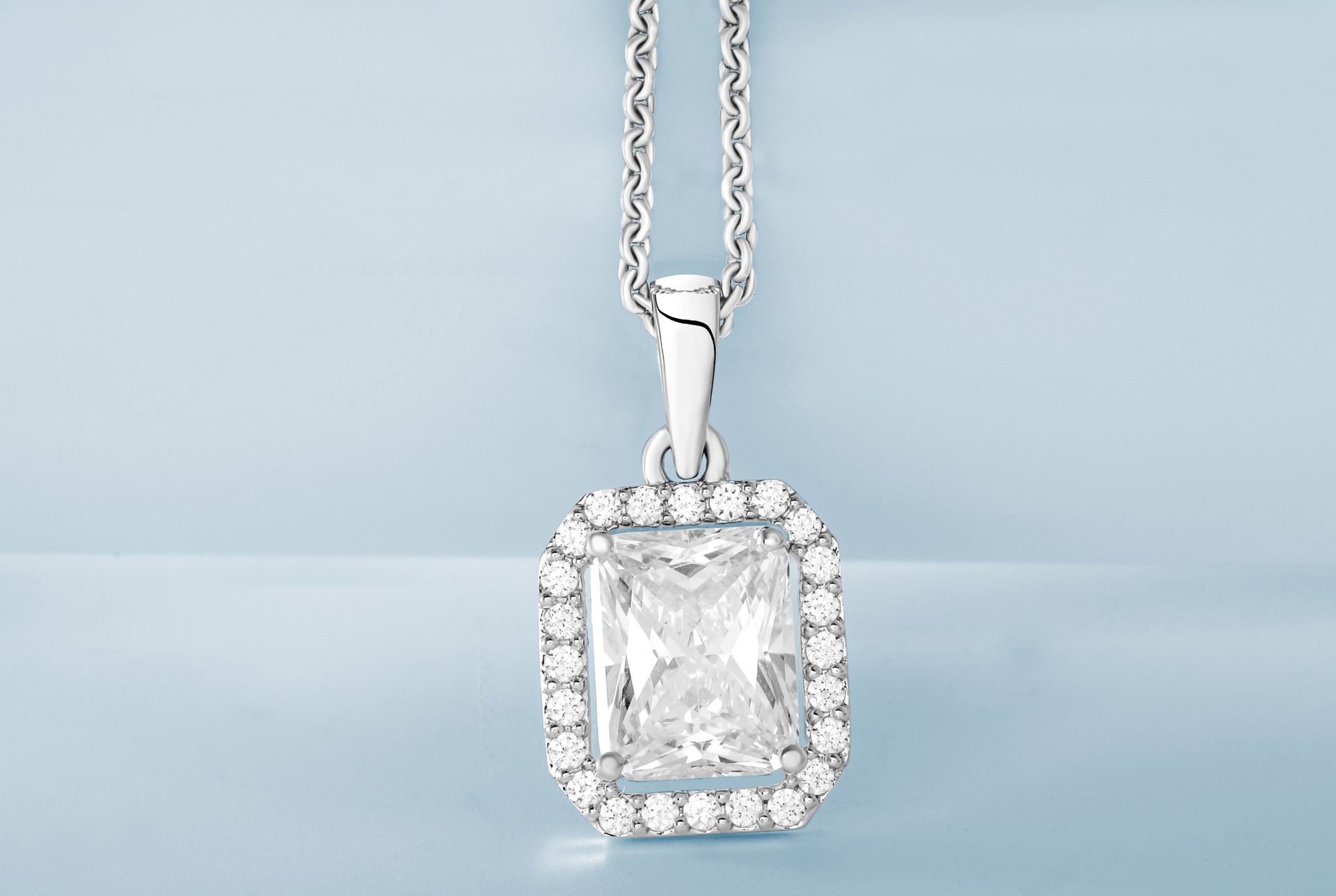 Silver Pendant with Diamonds in Close Up Photography