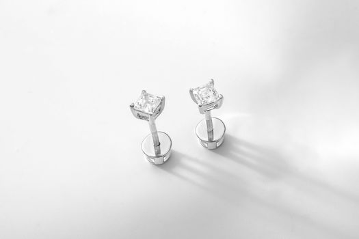 Close-up of luxury diamond stud earrings showcasing elegance and simplicity.