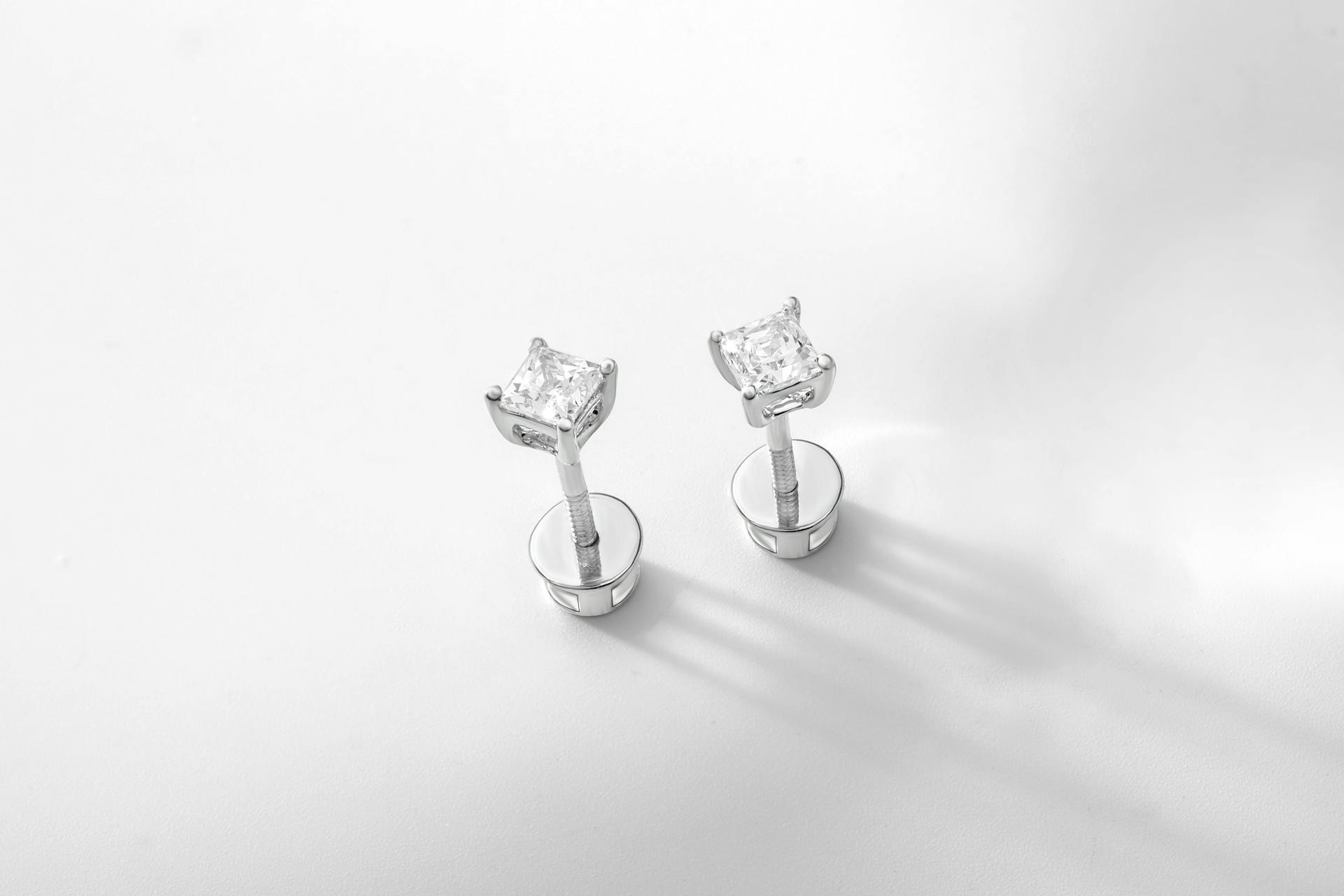 Close-up of luxury diamond stud earrings showcasing elegance and simplicity.