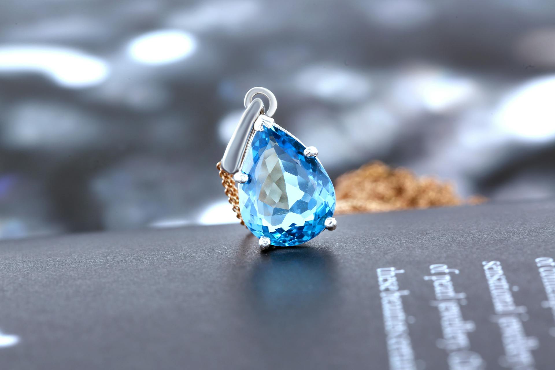 Close-up of a luxurious blue gemstone pendant on display, showcasing elegance and sophistication.