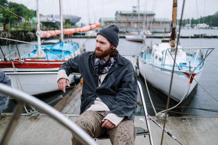 Man Sitting On A Chair On The Dock