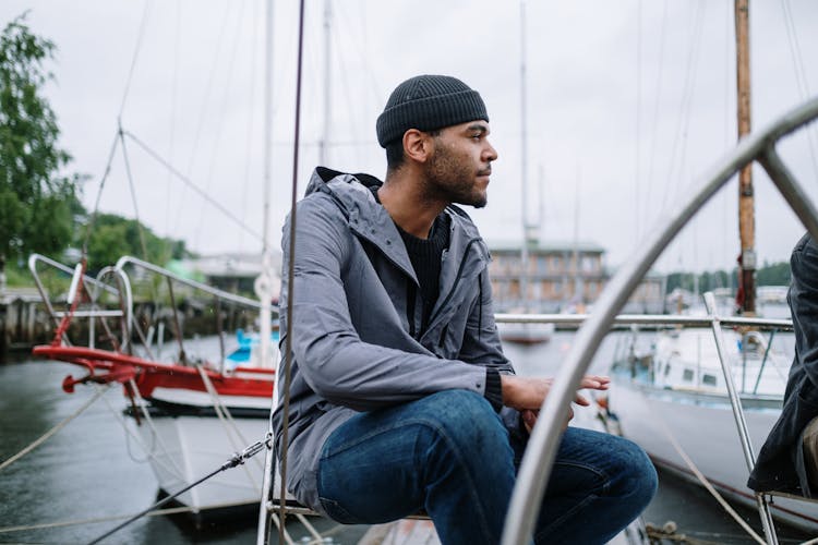 Man Sitting On A Chair On The Dock