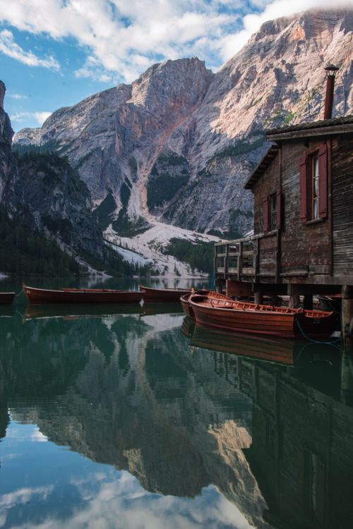 Brown Wooden Boats on Lake Near a Cabin · Free Stock Photo