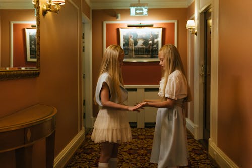 Free Girls in Dresses Standing in the Hallway of a Hotel  Stock Photo