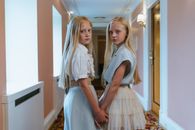 2 Girl in White Dress Sitting on White Chair