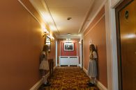 Woman in White Dress Standing on Hallway