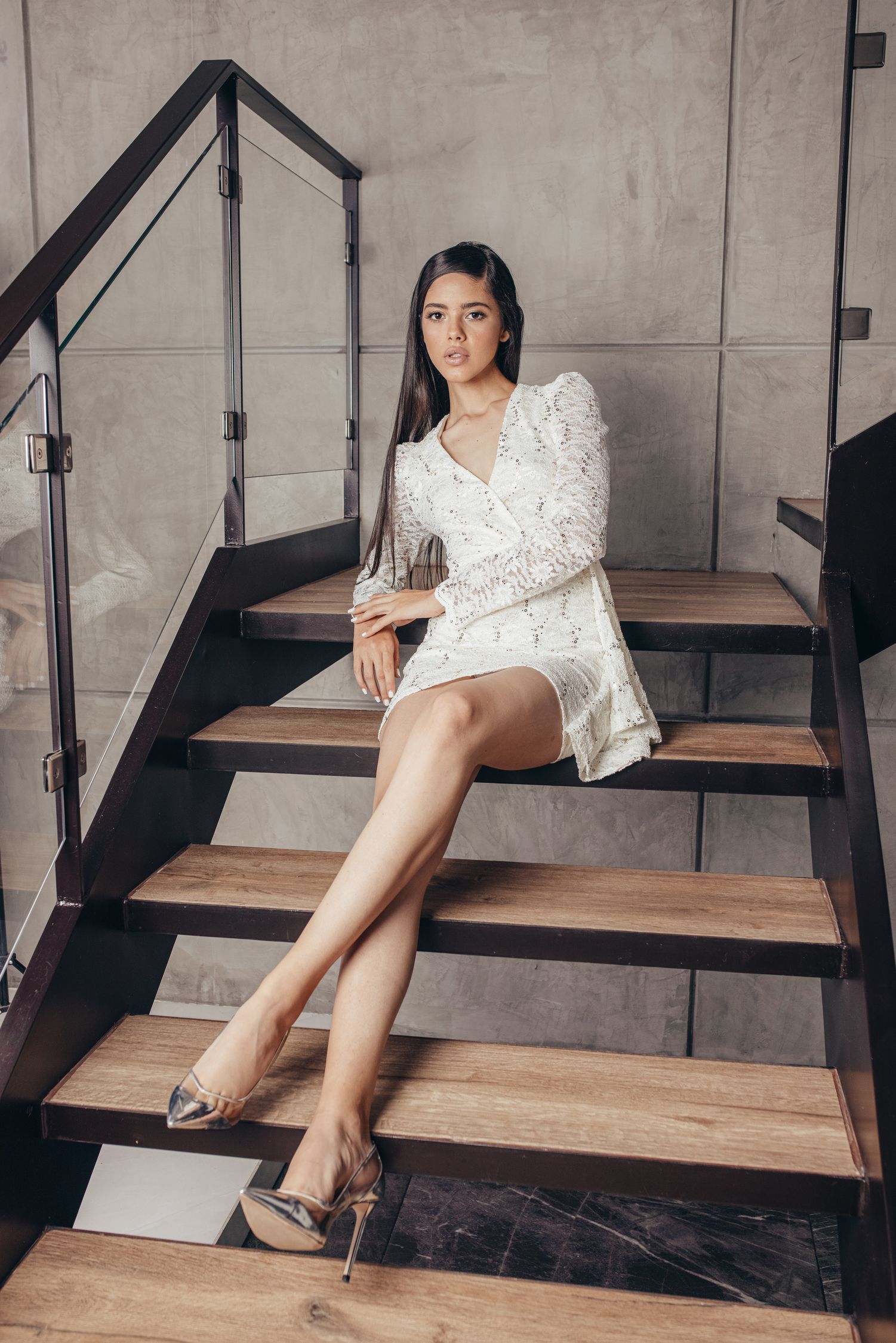 Glamorous woman sitting with legs crossed on staircase · Free Stock Photo