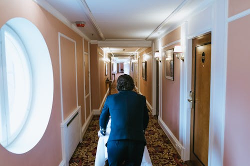 Bell Boy Walking at Corridor at Hotel
