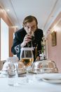 Man in Black Suit Drinking Beer