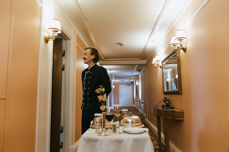 Guest Service Staff In Front Of A Hotel Room 