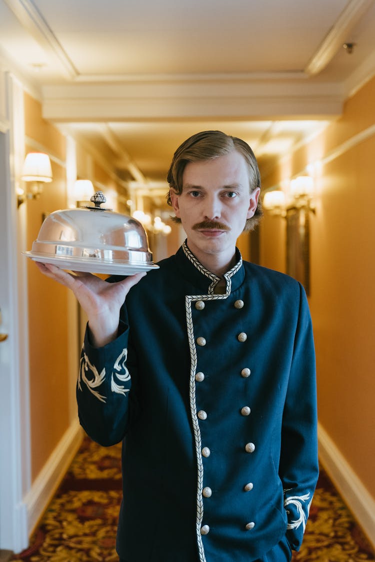 Guest Service Staff Carrying A Cloche 