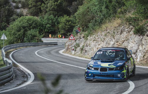 Blue Subaru WRX Racing on Asphalt Zigzag Road