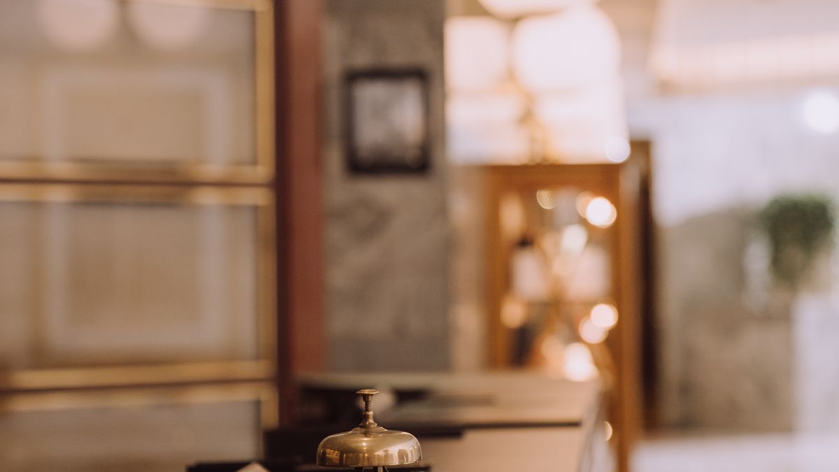 Hotel reception desk with a staff member checking in a guest