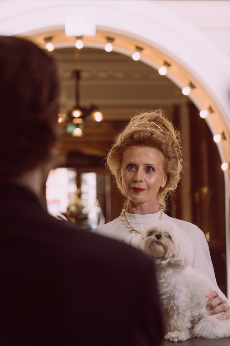 Aristocrat With Maltese Dog On Top Of Desk 