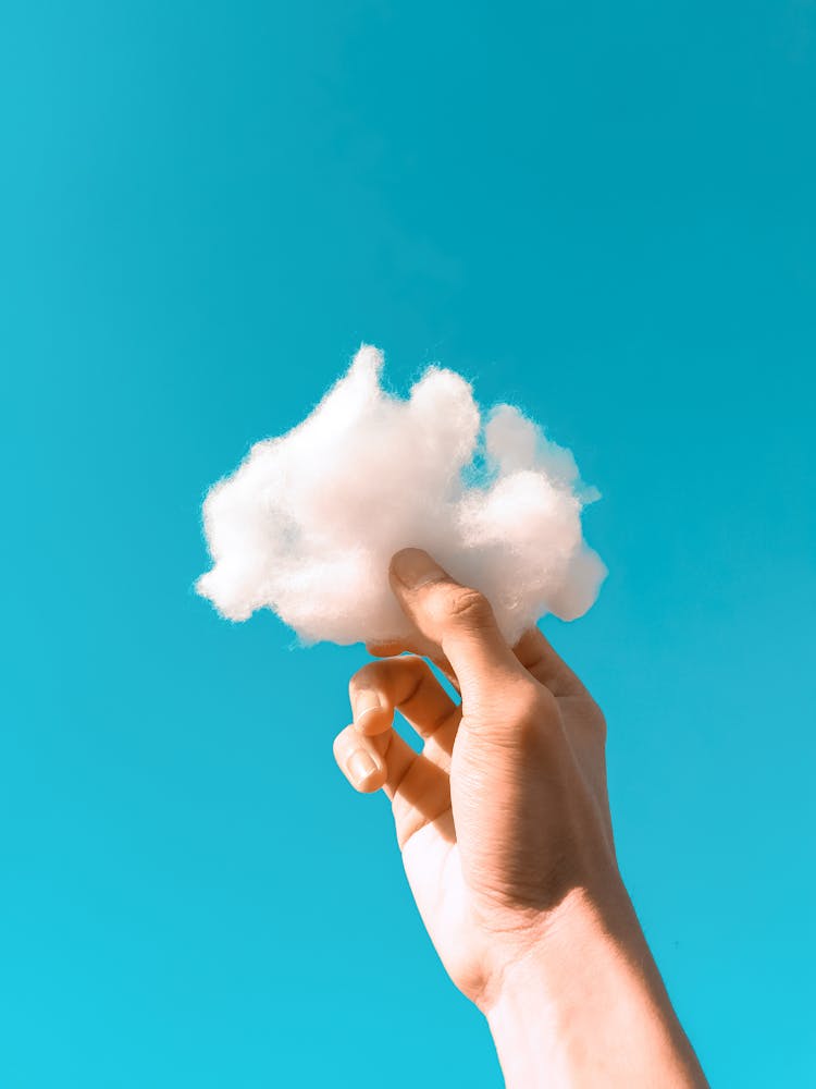 Hand Holding A Cloud Shaped Wool 