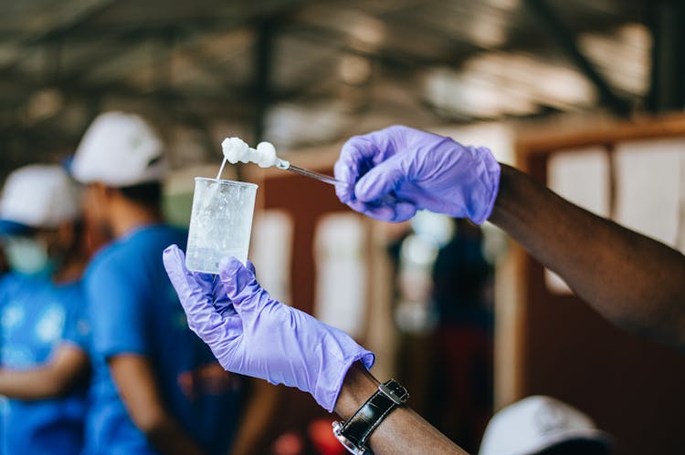 Diverse People In Medical Gloves Performing Experiment