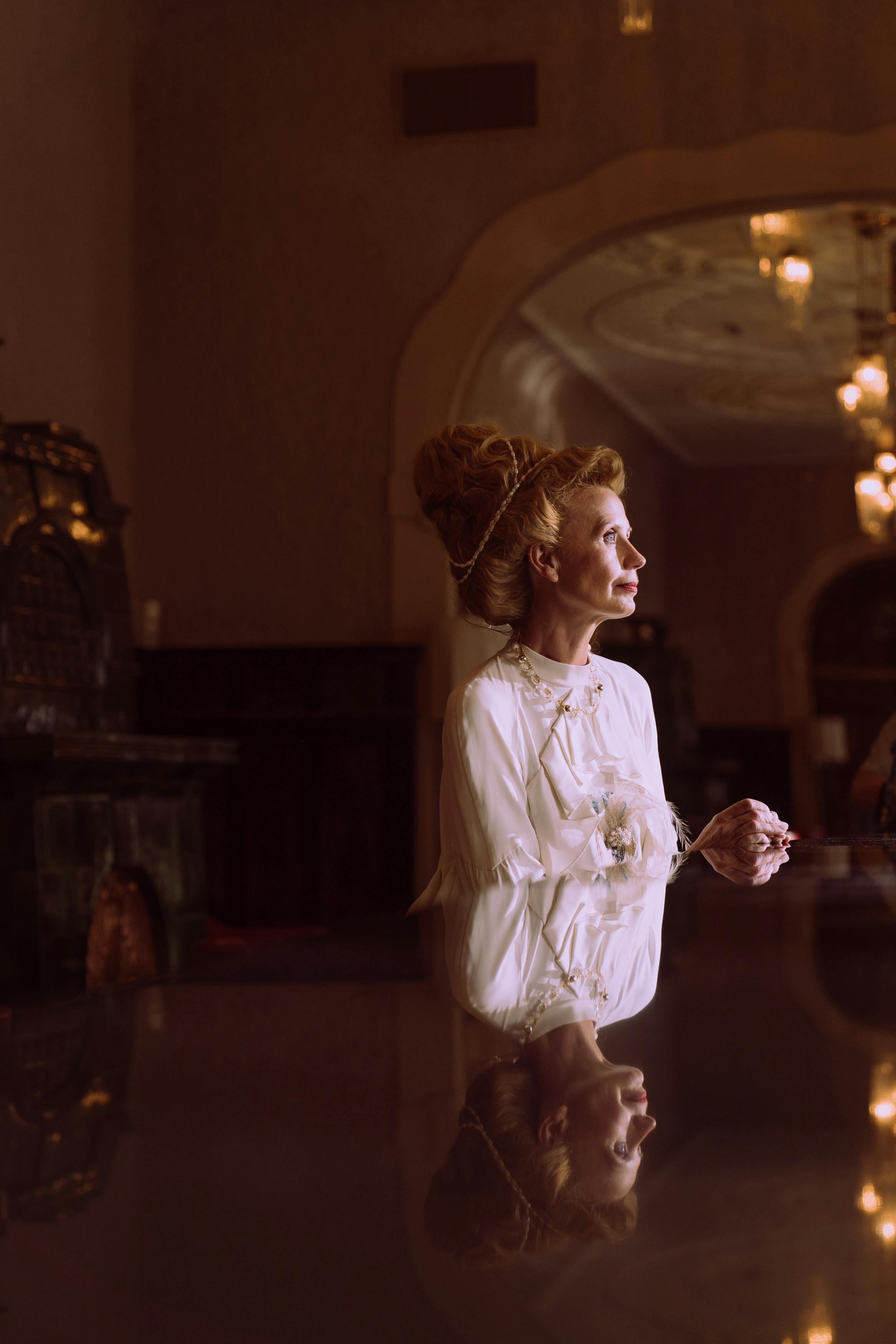 girl in white dress holding light bulb