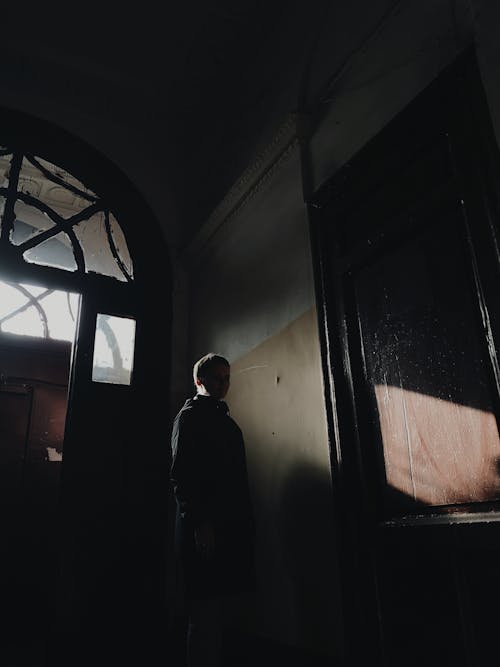 Man Standing in Front of Glass Door