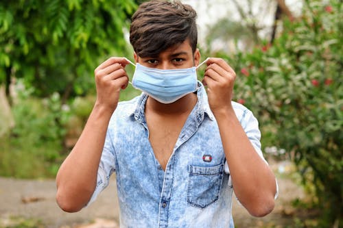 Man in Blue Denim Button Up Top