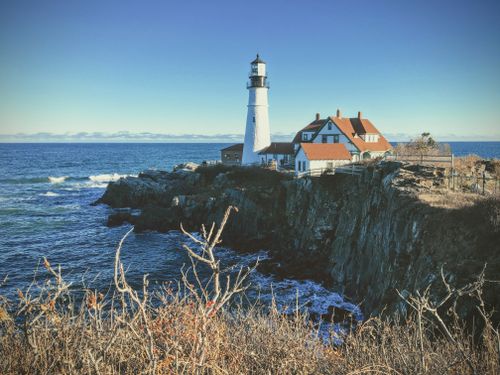 Free Beautiful view of the iconic Cape Elizabeth Lighthouse on a rocky Maine coast. Stock Photo