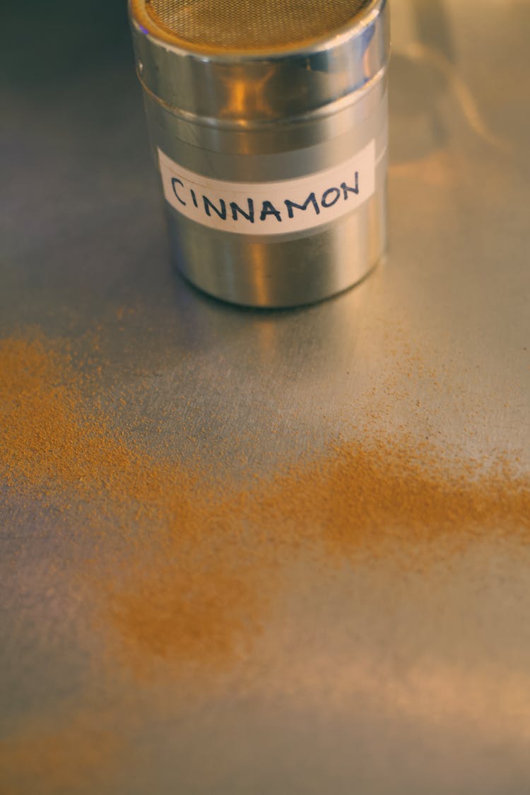 Scattered Cinnamon Powder Beside The  Seasoning Container