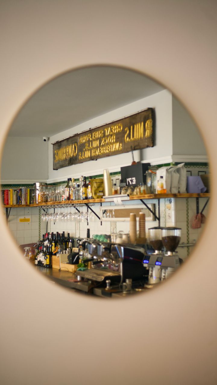 armoire with mirrored back panel creating a bright coffee station display