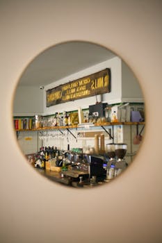 Cozy café interior with a vintage design reflected in a round mirror.