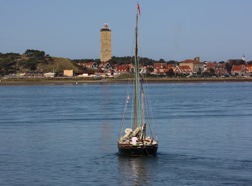 Free stock photo of lighthouse, sailing ship, sea bay