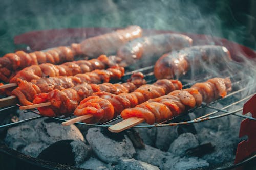 Free Meat on Skewers Grilling on a Barbecue Stock Photo