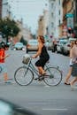 Woman in Black Tank Top and White Shorts Riding on Bicycle