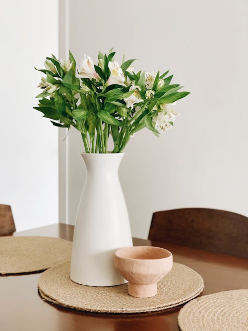 White Flowers in White Ceramic Vase on Wooden Table